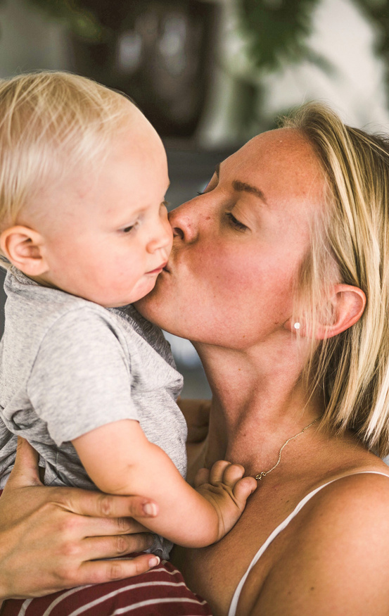 mom kissing her baby 