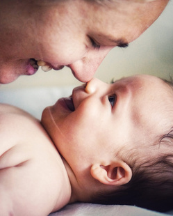 baby smiling at mom