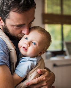 dad holding his baby close