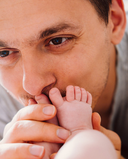 happy young father looking with tenderness at his baby 