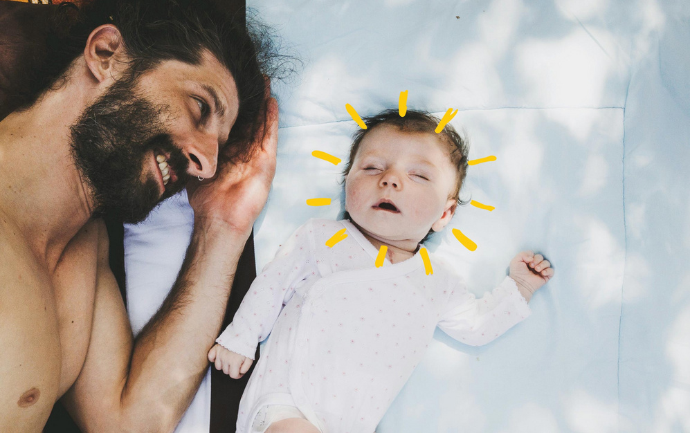 dad lying down beside sleeping baby sunshine