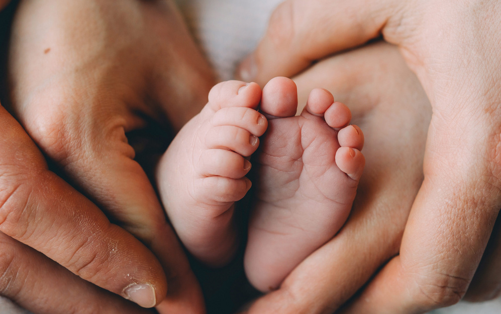 dad holding baby feet