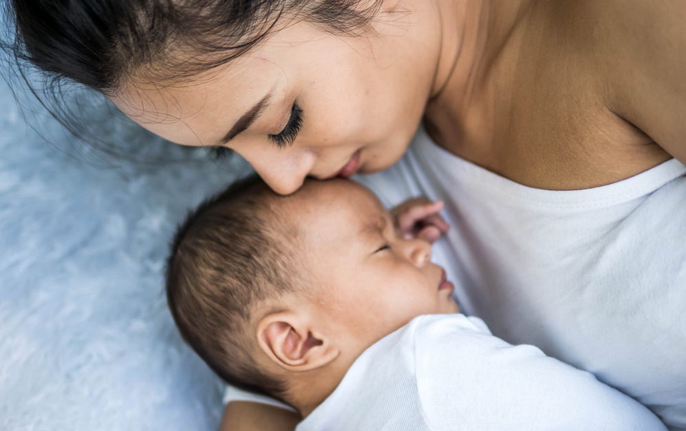 baby sleeping calmly beside mommy 