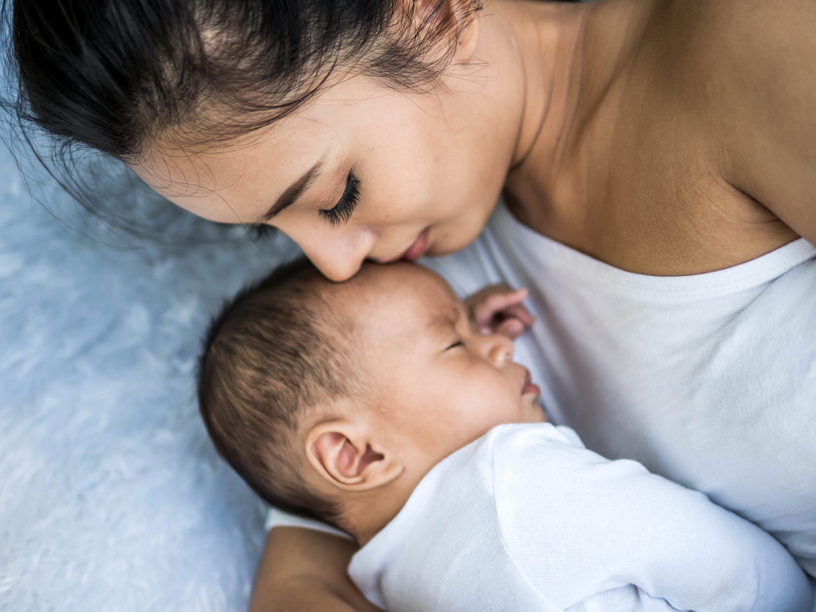 baby sleeping calmly beside mommy 