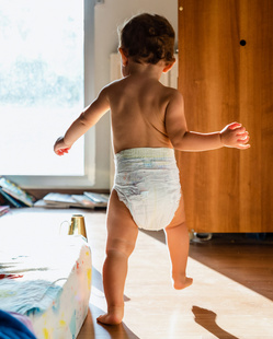 baby walking in diapers